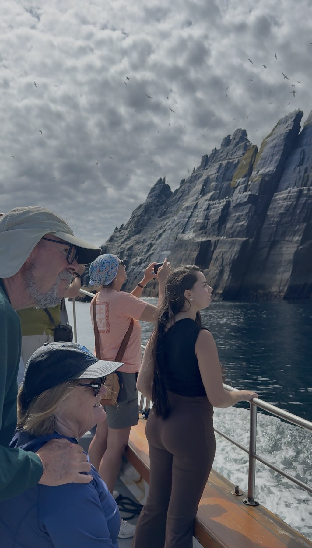 Passengers looking up at the Skellig cliffs