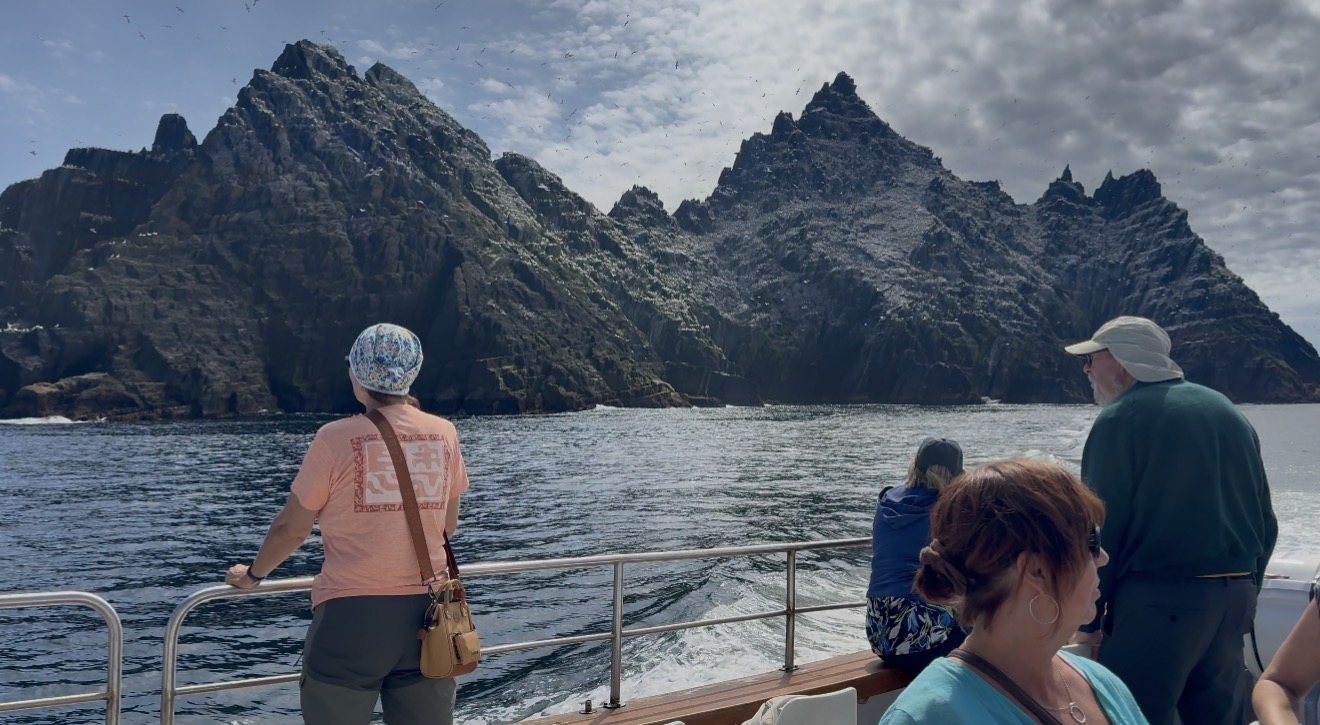 Guests aboard Skellig Boat Tour looking up at the Skellig rocks