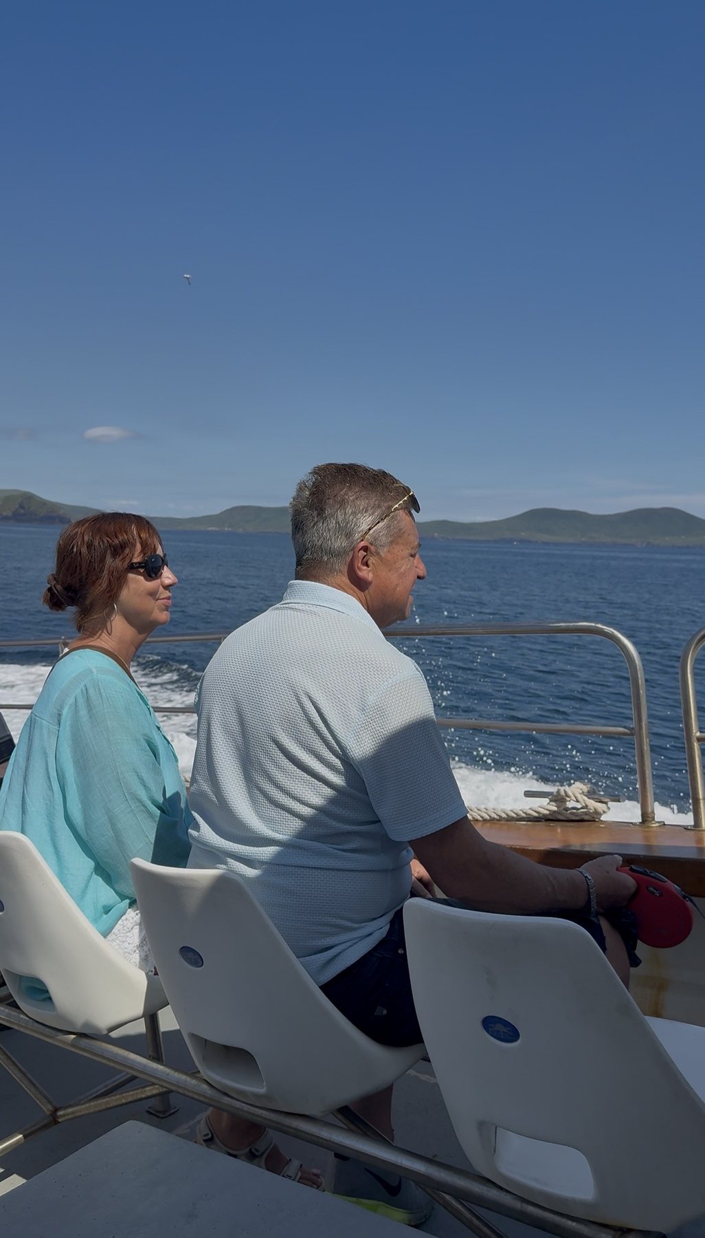 Couple seated on board looking across the Kerry coast