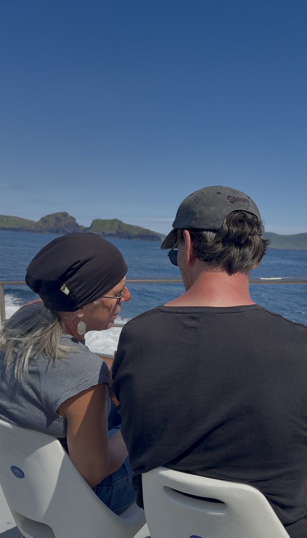 Couple watching the coastline from the boat